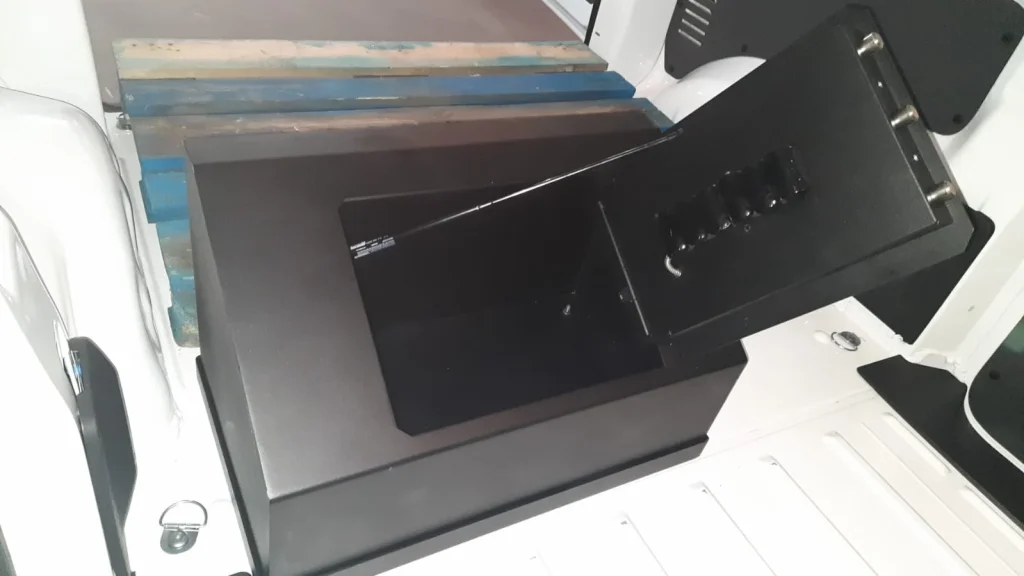 Caja fuerte para vehículos instalada en la parte trasera de un vehículo abierta se ve el interior